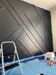 the wall is being painted black and it's been done with some paint on it