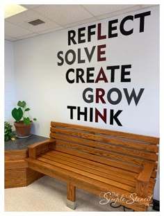 a wooden bench sitting in front of a wall that says reflect solve create grow think