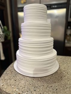 a large white cake sitting on top of a counter