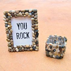 there is a rock frame next to a candle holder with a sign that says you rock