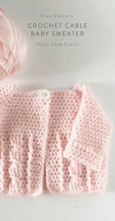 a pink knitted sweater with the words crochet cable baby sweater next to it