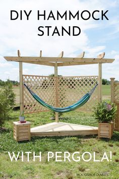 a hammock stand with a bench and potted plants in the grass under it