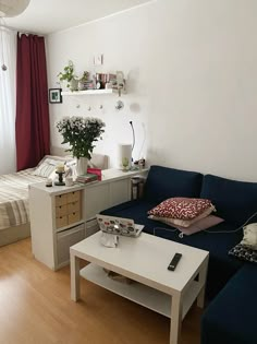 a living room filled with furniture and a white coffee table in front of a blue couch