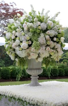 a large vase filled with lots of white flowers