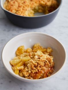 two bowls filled with food on top of a table