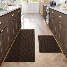 two brown rugs in the middle of a kitchen