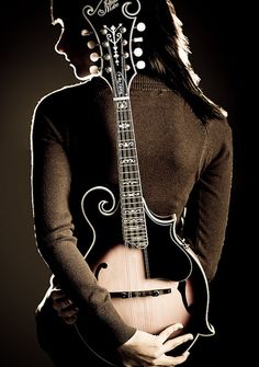 a woman holding an electric guitar in her hands