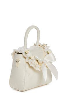 cuz you are the queen of gems. This handbag has a brocade construction with a bow design, flower and lace appliques, a bow in front adorned with a pearl charm, a top handle, a removable shoulder strap, and a front snap button closure. Party Cream Top Handle Bag, Cream Top Handle Party Bag, Cream Top Handle Party Bags, Cream Top Handle Bag For Party, Chic Wedding Bag With Bow, Chic Wedding Bags With Bow Detail, Chic Wedding Bags With Bow, Elegant Wedding Bags With Bow Detail, Elegant Wedding Bags With Bow