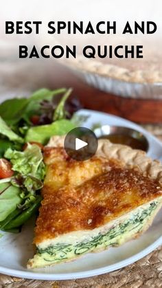 a white plate topped with a slice of quiche next to a salad