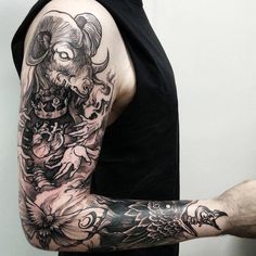 a man with a goat tattoo on his arm