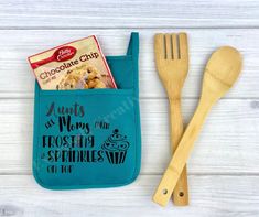 a wooden spoon and fork in a blue pocket with chocolate chip print on the side