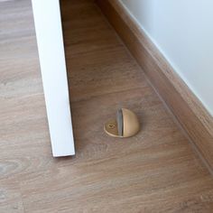 a wooden floor with a hole in the middle and a door handle next to it