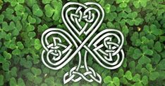 an irish shamrock with two intertwined hearts on it's center surrounded by green clovers