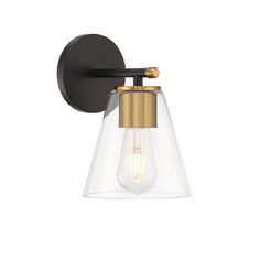 the brass and clear glass wall light is mounted on an old - fashioned black finish