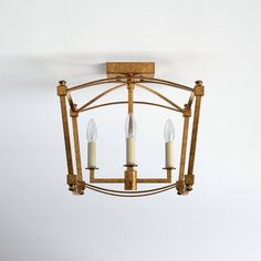 a chandelier with three candles hanging from it