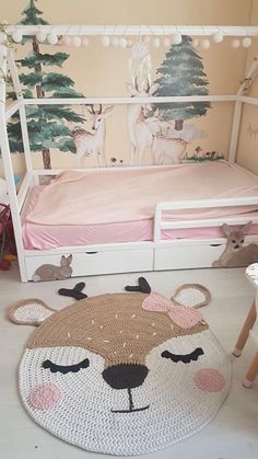 a child's bedroom with a bed and rugs on the floor