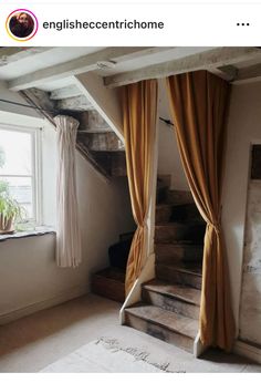 an image of a room with curtains on the window sill and stairs to the second floor