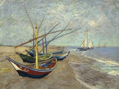 three boats are on the beach near the water