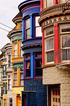 many multicolored buildings with balconies and windows