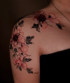 a woman's shoulder with flowers on it