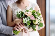 the bride and groom are holding their wedding bouquet