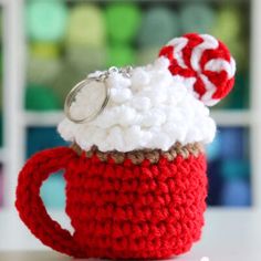 a crocheted mug with a candy cane in it