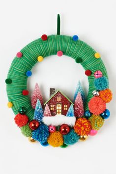 a christmas wreath with a house on it