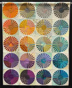 a quilt with many different colors on it