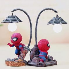 two spider - man figurines are sitting next to each other