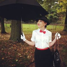 a woman holding an umbrella in the park