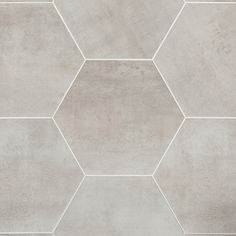 a white tile wall with hexagonal shapes