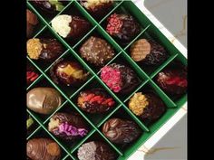 a green tray filled with lots of different types of chocolates