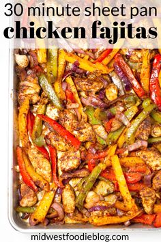 a pan filled with chicken, peppers and onions