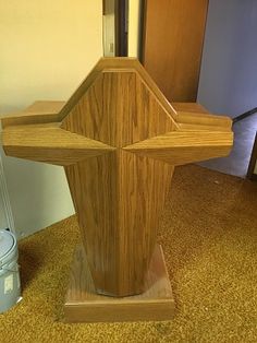 a wooden statue in the corner of a room