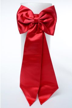 a red bow tie on top of a white mannequin