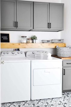 a white washer and dryer sitting next to each other in a laundry room