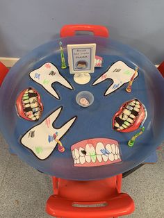 a child's toy table with toothbrushes and braces on it