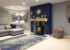 a living room filled with furniture and a fire place next to a wall mounted clock