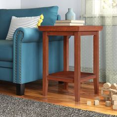 a living room with a blue couch and wooden blocks on the floor next to it