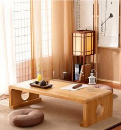 a wooden coffee table sitting on top of a carpeted floor next to a window