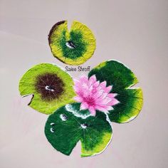 three leaves with flowers on them sitting next to each other