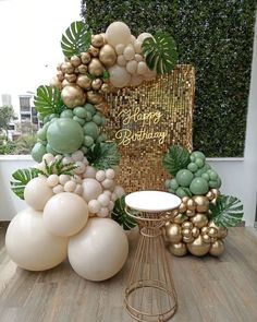 balloons and greenery are arranged on a table