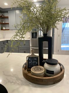 a kitchen counter with a coffee pot, mug and soap dispenser on it