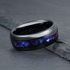 Materials - Tungsten,Sandstone Finish - Polished Band Color - Black Band Width - 4mm, 6mm, 8mm Free Rustic Wood Box Free Same Day Shipping This beautifully handcrafted ring is sure to get noticed everywhere you go! A rich black tungsten carbide mingles with sparkling sandstone creating a captivating inlay look that reflects our galaxy. The blue and purple sandstones are iridescent or color shifting which makes this ring so unique and breathtaking. Sandstone is composed of sand-sized silicate gra Priestess Jewelry, Sandstone Ring, Space Ring, Space Rings, Witch Rings, Rings Aesthetic, Galaxy Ring, Celestial Ring, Dark Witch