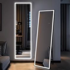 an illuminated mirror in the middle of a room with a couch and chair next to it