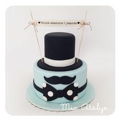 a cake with a top hat, mustache and bow tie on it