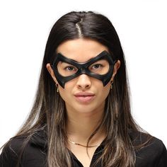 a woman wearing a black mask on her face