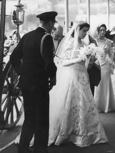 an old black and white photo of a bride walking down the aisle with her father