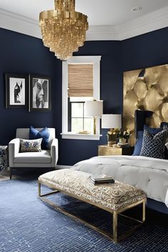 a bedroom with blue walls and gold accents