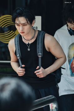 a man wearing suspenders and a black shirt